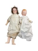 A pair of German bisque head dolls, to include: - An Armand Marseille, marked to back of head: AM-