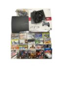 A boxed Playstation 3 games console and controller, together with a collection of games