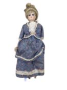 A modern porcelain head doll on stand with striking blue eyes and blue dress. Height