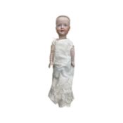 A Simon and Halbig 151 bisque head character doll with blue painted eyes in cotton gown. Marked to