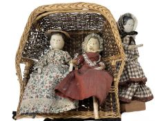A trio of early 20th century wooden doll ladies on a cane seat / one on stand. Hand-painted faces,