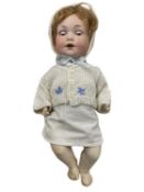 An Armand Marseille bisque head character doll, with brown weighted eyes and open mouth with teeth