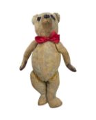 A well-loved vintage teddy bear with growling mechanism.