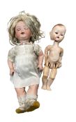 A pair of dolls, to include: - A German AM Koppelsdorf bisque head doll, in white dress with blue