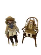 A pair of small bisque head dolls on wooden stick back chairs. One unmarked, the other a Max Oscar
