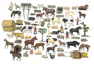 A large collection of various die-cast farm animals, figures and outbuildings