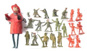 A vintage Louis Marx clockwork 'Smokey Joe' fireman, together with various toy soldiers. Damage to