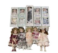 An assortment of modern porcelain collectors dolls, some boxed.