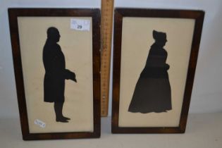 Pair of silhouette portrait pictures of a lady and gent