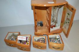 Small table top cabinet containing assorted costume jewellery
