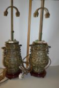 A pair of Chinese metal lamps decorated in archaistic fashion on wooden bases, lamp body is 32cm
