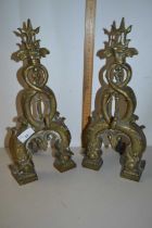 Pair of brass fire dogs formed as intertwined serpents