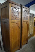 Two Victorian oak single door cabinets formerly part of a larger piece
