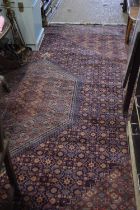 Large 20th Century patterned floor rug with central lozenge and a mainly blue and red background