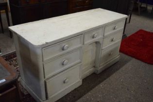 White painted 19th Century dresser base with seven drawers and a centre door, 155cm wide