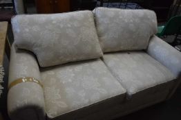 Two seater beige sofa
