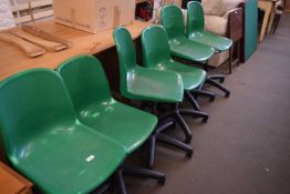 Six green plastic swivel office chairs