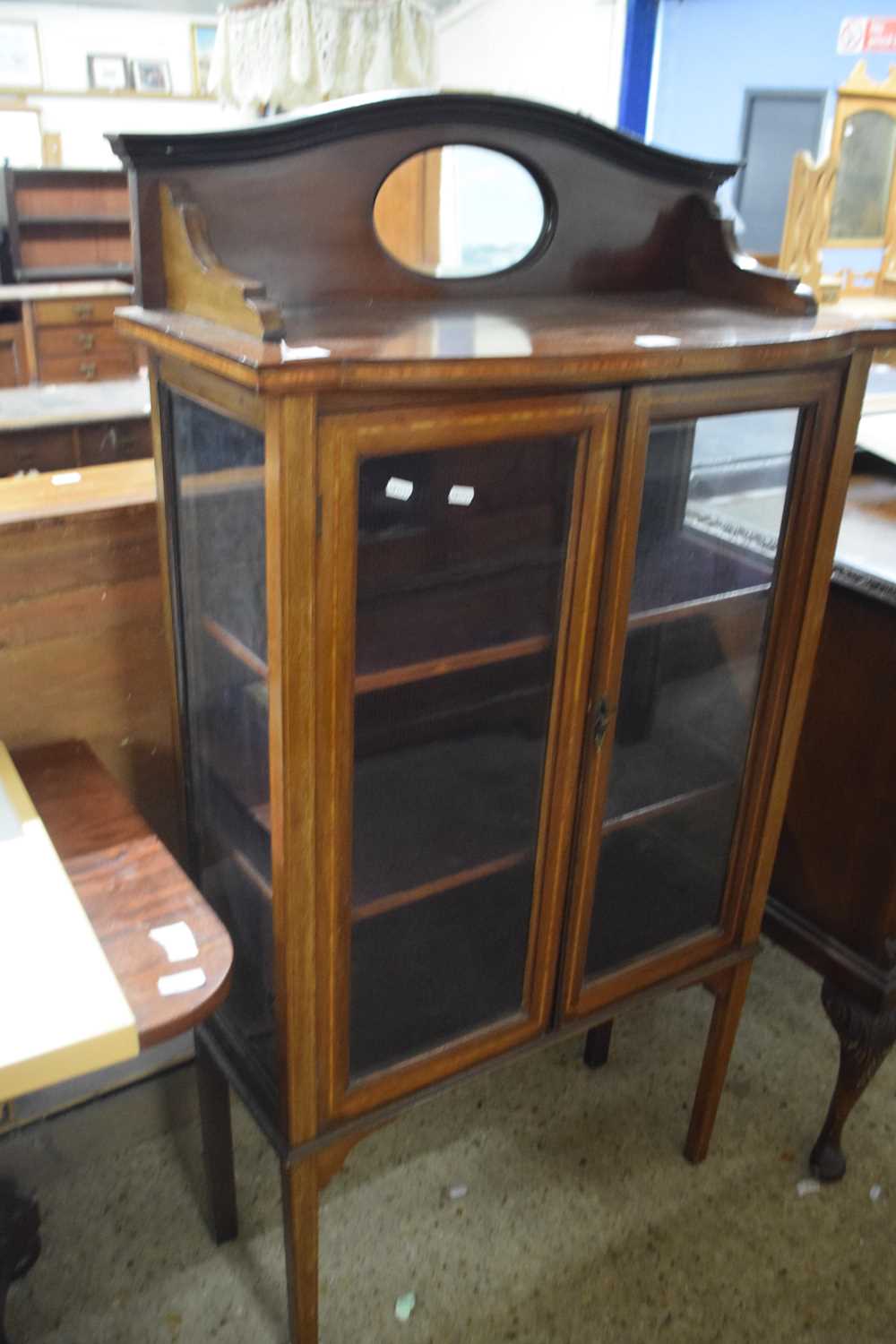 An Edwardian mahogany mirror back display cabinet
