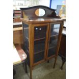 An Edwardian mahogany mirror back display cabinet