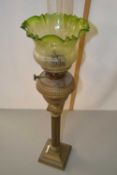 Brass based oil lamp with frilled green glass tinted font