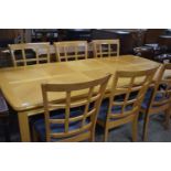 Modern oak extending dining table and six mesh back chairs