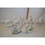 A set of four bisque porcelain vases formed as carts driven by goats together with a further pair of