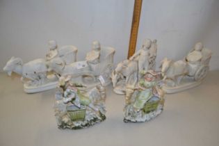 A set of four bisque porcelain vases formed as carts driven by goats together with a further pair of