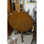 Mahogany circular top supper table raised on a turned column and tripod base with paw feet