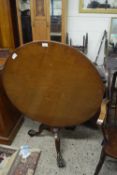 Mahogany circular top supper table raised on a turned column and tripod base with paw feet