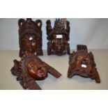 Two pairs of South East Asian carved wall masks