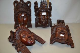 Two pairs of South East Asian carved wall masks