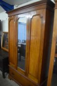 Late Victorian American walnut wardrobe with mirrored centre door, 125cm wide