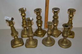 Group of eight brass candlesticks