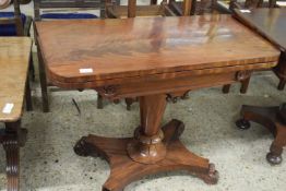 19th Century mahogany card table with folding top over a turned column and a platform base