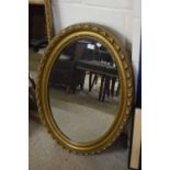 Early 20th Century oval bevelled wall mirror in gilt finish frame