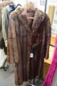 A lady's brown fur coat