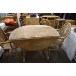 Folding oval table together with a set of four wheel back chairs