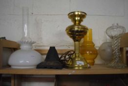 Quantity of various oil lamp shades together with a brass oil lamp