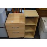 Light wood finish two drawer chest and a similar revolving bookcase (2)