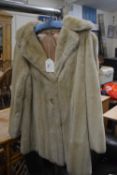 A lady's cream faux fur jacket