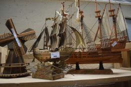 Two ship models together with a similar wooden windmill model