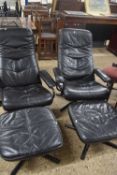 A pair of black leather upholstered and metal framed recliner chairs with footstools (4)