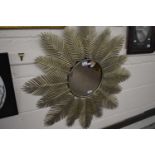 Sophisticated garden mirror with central circular mirror plate surrounded by metal palm leaf fronds