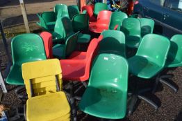 Large quantity of plastic revolving desk chairs and others