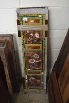 A pair of Victorian fireside tile panels decorated with flowers, 97cm high including backing