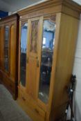 Late Victorian American walnut wardrobe with carved decoration and two mirrored doors, 112cm wide