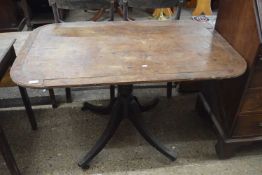 Small Georgian mahogany dining table with rectangular top over a turned column and four outswept