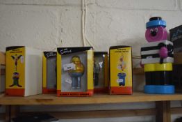 Five various "The Simpsons" novelty bottle openers together with a Bertie Bassett figure