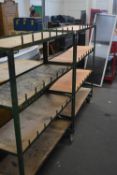 Pair of four tier shelving units on casters