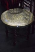A Middle Eastern style brass top folding table